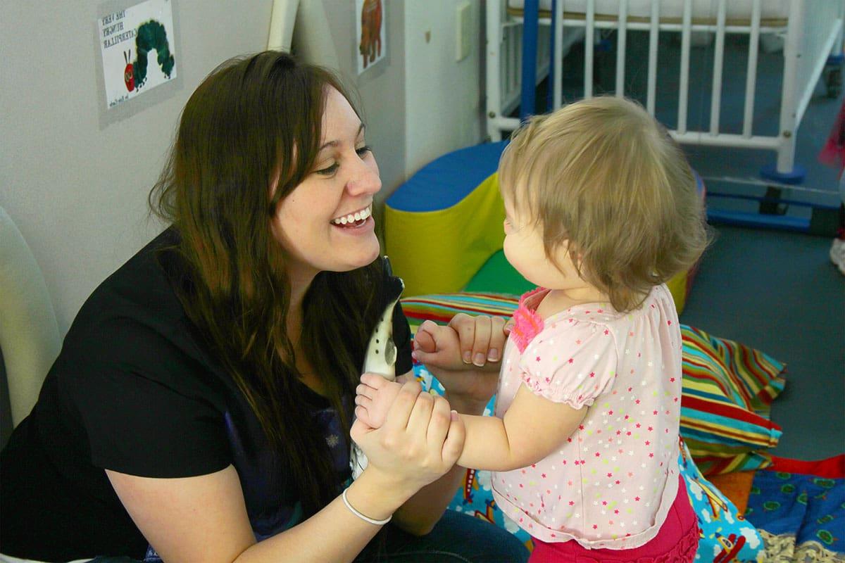 A CFDC teacher tending to a toddler